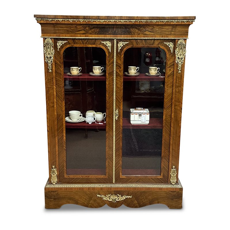 English antique walnut two door vitrine with ormolu mounts and mouldings and crossbanded door panels